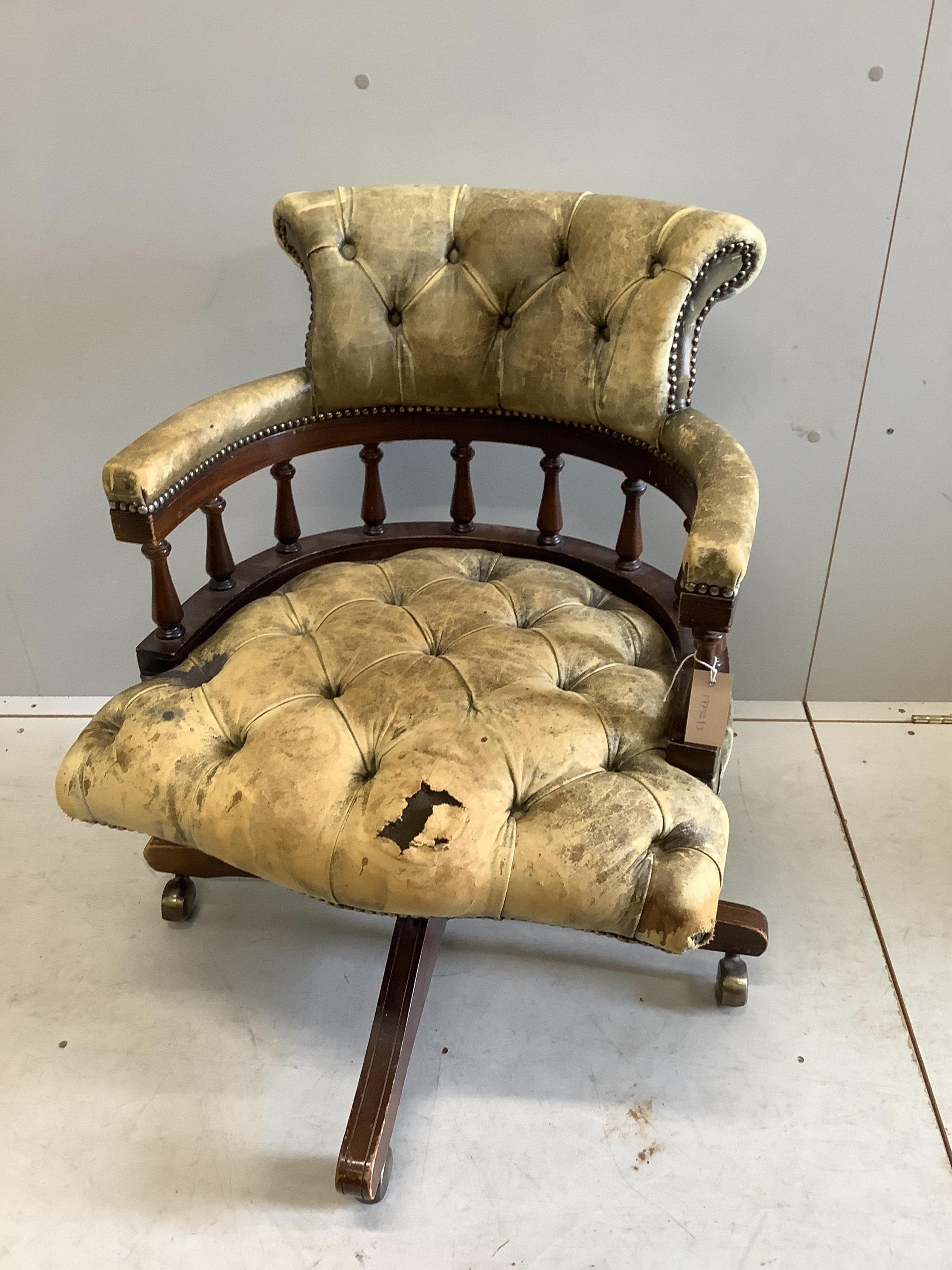 A reproduction Victorian style buttoned leather beech swivel desk chair, width 61cm, depth 58cm, height 80cm. Condition - poor